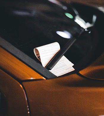 Photo by Erik Mclean: https://www.pexels.com/photo/parking-ticket-behind-the-windshield-wipers-12641792/